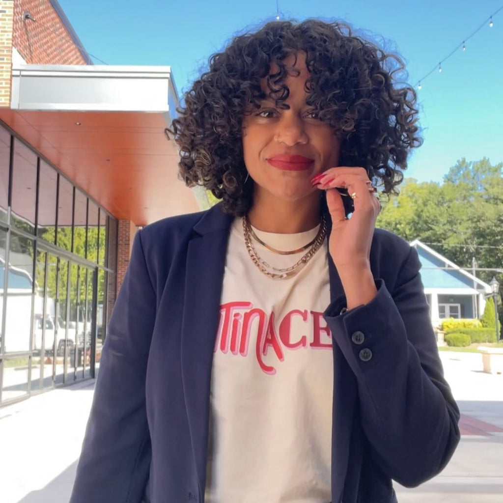 curly latina wearing an ivory shirt latina ceo
